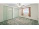 Bedroom features a ceiling fan, a window, and double closets at 2192 Hyatt Dr, Port Charlotte, FL 33948