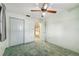 Bedroom with a ceiling fan, closet, neutral walls and green trim at 2192 Hyatt Dr, Port Charlotte, FL 33948