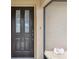 Elegant front door with glass panels, a security system sign, and textured exterior walls at 2192 Hyatt Dr, Port Charlotte, FL 33948