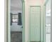 Hallway showcasing a bedroom and bathroom with lovely muted green trim and painted doors at 2192 Hyatt Dr, Port Charlotte, FL 33948