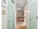 Hallway with decorative floor tiles, light-colored walls, and multiple doors leading to other rooms at 2192 Hyatt Dr, Port Charlotte, FL 33948