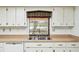 Functional kitchen featuring a double sink, wood-look countertops, and white cabinetry at 2192 Hyatt Dr, Port Charlotte, FL 33948