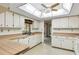 Well-lit kitchen with a bright skylight, abundant counter space, and white cabinetry at 2192 Hyatt Dr, Port Charlotte, FL 33948