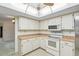 Bright kitchen showcasing white appliances, skylight, and plenty of cabinet and counter space at 2192 Hyatt Dr, Port Charlotte, FL 33948