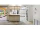 Open kitchen layout with breakfast bar, stainless steel refrigerator, and ample cabinet space at 2192 Hyatt Dr, Port Charlotte, FL 33948