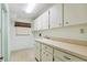 Laundry room featuring lots of storage, a sink, a window, and neutral walls at 2192 Hyatt Dr, Port Charlotte, FL 33948