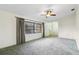Bright living room features a ceiling fan and window with blinds at 2192 Hyatt Dr, Port Charlotte, FL 33948
