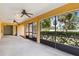 Covered patio with ceiling fans and view of screened-in area and landscaping at 2192 Hyatt Dr, Port Charlotte, FL 33948