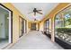 Enclosed patio with ceiling fans, screens, and sliding glass doors to the interior at 2192 Hyatt Dr, Port Charlotte, FL 33948