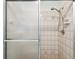 Tiled shower with glass door and updated shower head in this cozy bathroom at 2192 Hyatt Dr, Port Charlotte, FL 33948