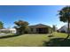 Expansive backyard with lush green lawn and screened in lanai at 2227 Bonn Ct, Punta Gorda, FL 33983