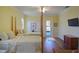 Bright bedroom with two twin beds, wooden floors, and an exterior door for easy access at 2227 Bonn Ct, Punta Gorda, FL 33983