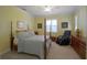 Comfortable bedroom with a four-poster bed, shuttered window and comfortable massage chair at 2227 Bonn Ct, Punta Gorda, FL 33983