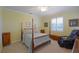 Comfortable bedroom with a four-poster bed, shuttered window and comfortable massage chair at 2227 Bonn Ct, Punta Gorda, FL 33983