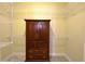A walk-in closet with wire shelving and a wooden armoire for storage at 2227 Bonn Ct, Punta Gorda, FL 33983