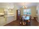 Dining area featuring modern chandelier, wood floors, and seamless flow to the kitchen at 2227 Bonn Ct, Punta Gorda, FL 33983