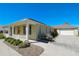 Single story home featuring a cozy front porch and a long driveway leading to a two-car garage at 2227 Bonn Ct, Punta Gorda, FL 33983
