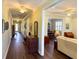 Long hallway featuring hardwood floors connecting multiple rooms and a rear entryway door at 2227 Bonn Ct, Punta Gorda, FL 33983