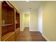 Hallway featuring hardwood floors, an ornate bookcase and neutral wall paint at 2227 Bonn Ct, Punta Gorda, FL 33983