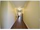 Long hallway with shiny wood floors, decorative chair rail, and ceiling fans at 2227 Bonn Ct, Punta Gorda, FL 33983