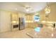 Well-lit kitchen with stainless steel appliances, granite countertops, and ample storage space at 2227 Bonn Ct, Punta Gorda, FL 33983