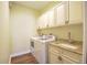 Laundry room featuring washer, dryer, sink, and cabinet storage at 2227 Bonn Ct, Punta Gorda, FL 33983