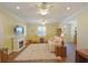 Cozy living room with fireplace, plush seating, ceiling fans, and bright natural light at 2227 Bonn Ct, Punta Gorda, FL 33983