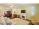 Comfortable living area with a decorative fireplace, and an open layout to the dining area at 2227 Bonn Ct, Punta Gorda, FL 33983