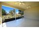 Covered screened lanai with ceiling fans overlooking a backyard at 2227 Bonn Ct, Punta Gorda, FL 33983