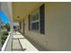 Covered porch featuring a seating area, and a beautifully textured exterior wall with black shutters at 2227 Bonn Ct, Punta Gorda, FL 33983