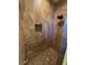 Tiled shower stall with a built-in niche and grab bar for accessibility at 2227 Bonn Ct, Punta Gorda, FL 33983
