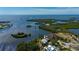 Aerial view of the home and the surrounding waterfront location with nearby islands and canals at 24139 Jolly Roger Blvd, Punta Gorda, FL 33955