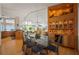 Dining room with a modern table and display shelving, seamlessly connecting to the kitchen and living areas at 24139 Jolly Roger Blvd, Punta Gorda, FL 33955