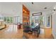 Dining area with modern lighting and views to both the living area and outdoor scenery at 24139 Jolly Roger Blvd, Punta Gorda, FL 33955
