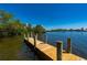 Dock view of canal with wooden posts and pilings, offering easy access to boating and water activities at 24139 Jolly Roger Blvd, Punta Gorda, FL 33955