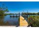 Dock view on the canal with boat lift, offering direct access to the open water and clear blue sky at 24139 Jolly Roger Blvd, Punta Gorda, FL 33955