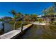 Private dock with boat lift and access to a boat house with a scenic view of the beautiful home at 24139 Jolly Roger Blvd, Punta Gorda, FL 33955