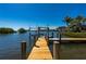 A private wooden dock provides access to the water and a boat lift at 24139 Jolly Roger Blvd, Punta Gorda, FL 33955