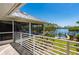 An elevated view of the exterior with a screened patio and metal roof overlooking the canal at 24139 Jolly Roger Blvd, Punta Gorda, FL 33955