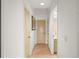 Hallway with wood floors leads to rooms and bathroom at 24139 Jolly Roger Blvd, Punta Gorda, FL 33955
