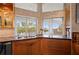 Modern kitchen with a stainless steel sink, dark granite countertops, and a lovely water view at 24139 Jolly Roger Blvd, Punta Gorda, FL 33955