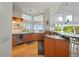 Bright, spacious kitchen with light wood cabinets, granite countertops, and abundant natural light at 24139 Jolly Roger Blvd, Punta Gorda, FL 33955