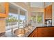 Modern kitchen with a stainless steel sink, dark granite countertops, and a lovely water view at 24139 Jolly Roger Blvd, Punta Gorda, FL 33955