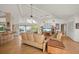 Open living room with high ceilings, light hardwood floors, and a comfortable seating arrangement at 24139 Jolly Roger Blvd, Punta Gorda, FL 33955