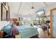 Spacious bedroom features a ceiling fan, a flatscreen TV, and deck access at 24139 Jolly Roger Blvd, Punta Gorda, FL 33955