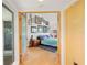Entry way and open view of a bright main bedroom featuring hardwood floors and unique decorations at 24139 Jolly Roger Blvd, Punta Gorda, FL 33955