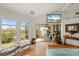 Bright bedroom boasts views of the water, modern decor, and deck access at 24139 Jolly Roger Blvd, Punta Gorda, FL 33955