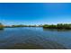 Scenic waterfront view, showing the tranquil canal and surrounding mangroves under a clear blue sky at 24139 Jolly Roger Blvd, Punta Gorda, FL 33955