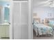 Bedroom showcasing ensuite bathroom featuring a vanity and a bedroom with two twin beds at 25100 Sandhill Blvd # R202, Punta Gorda, FL 33983