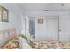 Bedroom showcases an ensuite bathroom featuring coastal style decor and a queen-size bed at 25100 Sandhill Blvd # R202, Punta Gorda, FL 33983